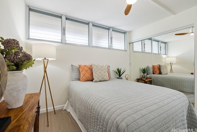 bedroom with ceiling fan and wood-type flooring