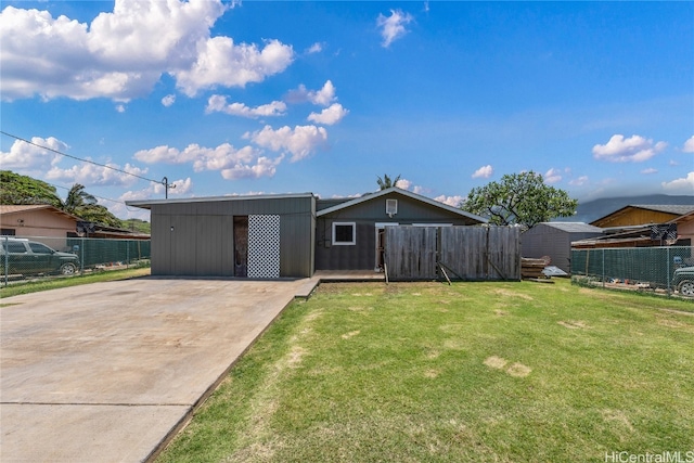 rear view of property with a lawn