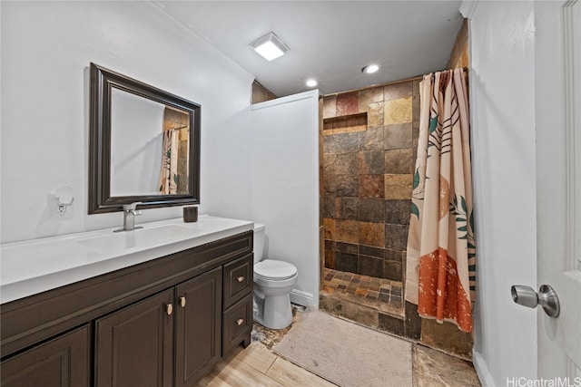 bathroom featuring walk in shower, vanity, crown molding, wood-type flooring, and toilet