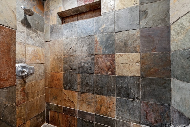 interior details with a tile shower