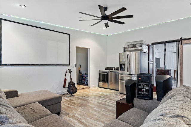 613 Kalakaua St, Wailuku, HI 96793 - home theater featuring separate washer and dryer, ceiling fan, and wood finished floors
