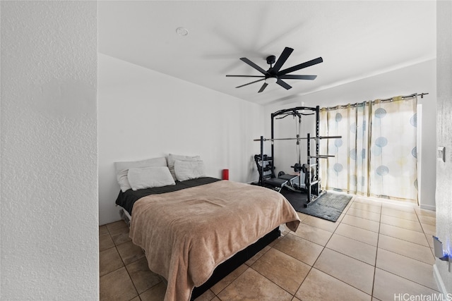 bedroom with ceiling fan and light tile patterned flooring