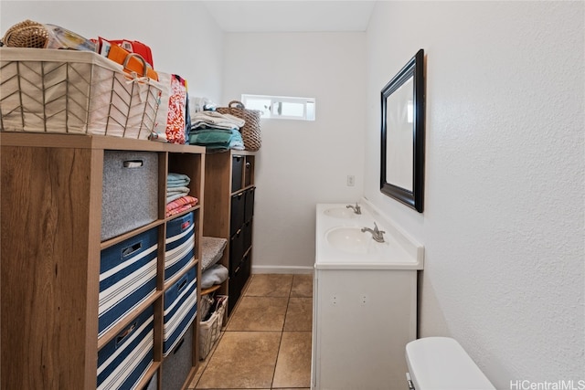 bathroom featuring tile patterned flooring, vanity, and toilet