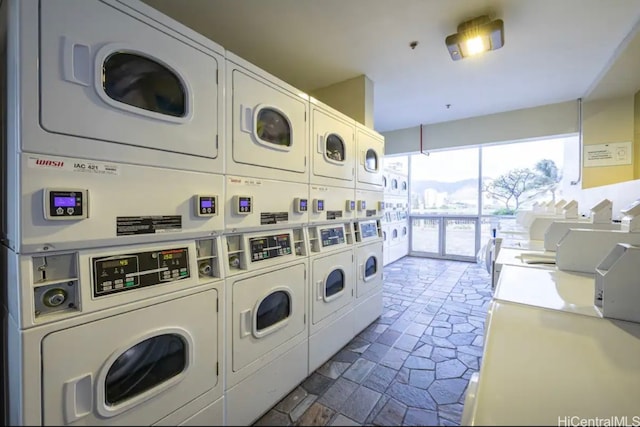 laundry room featuring washer and clothes dryer and stacked washer / drying machine