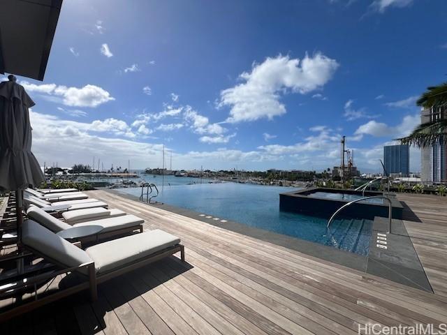 dock area with a water view and a jacuzzi