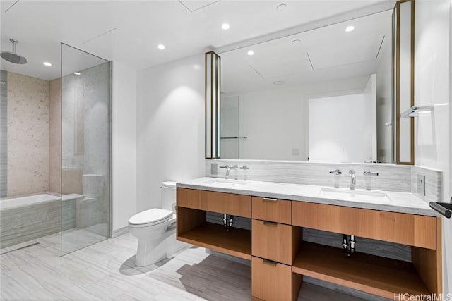 full bath featuring a walk in shower, double vanity, a sink, and toilet