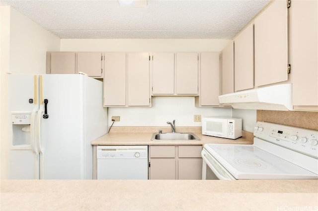 kitchen with a textured ceiling, white appliances, and sink