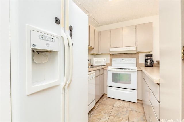 kitchen featuring a textured ceiling and white appliances