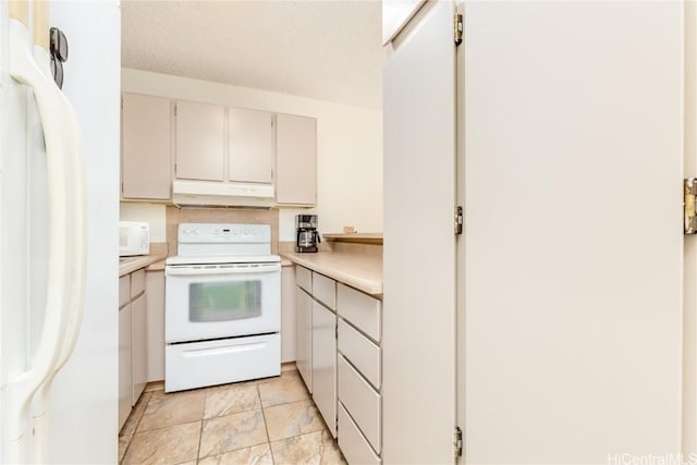 kitchen with a textured ceiling, white cabinets, and white appliances