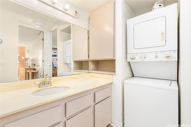 bathroom with vanity and stacked washer and clothes dryer