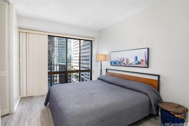 bedroom with wood-type flooring and a textured ceiling