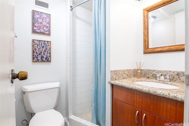 bathroom featuring vanity, a shower with shower curtain, and toilet