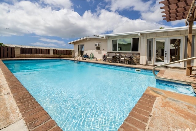 view of swimming pool with french doors and a patio