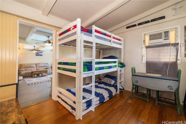 bedroom with vaulted ceiling with beams, a wall mounted air conditioner, and dark wood-type flooring