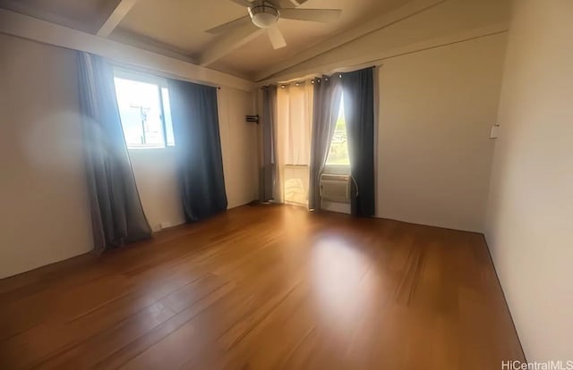 empty room with ceiling fan, lofted ceiling, and wood-type flooring