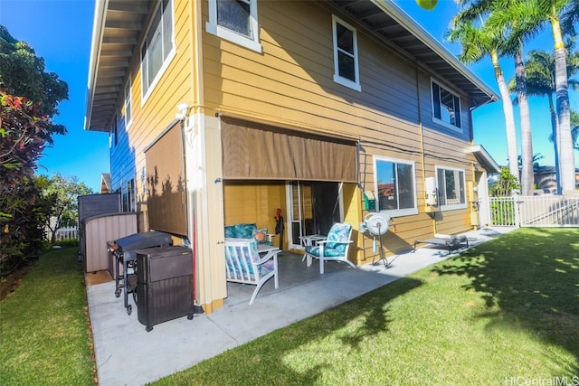 rear view of house featuring a patio area and a yard