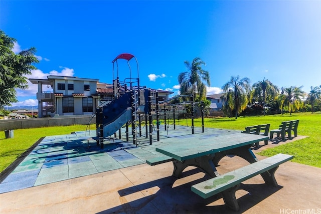 view of home's community with a playground and a yard