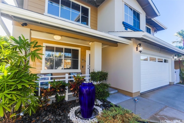 doorway to property featuring covered porch and a garage