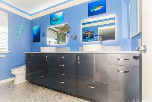 bathroom featuring vanity, toilet, and ornamental molding