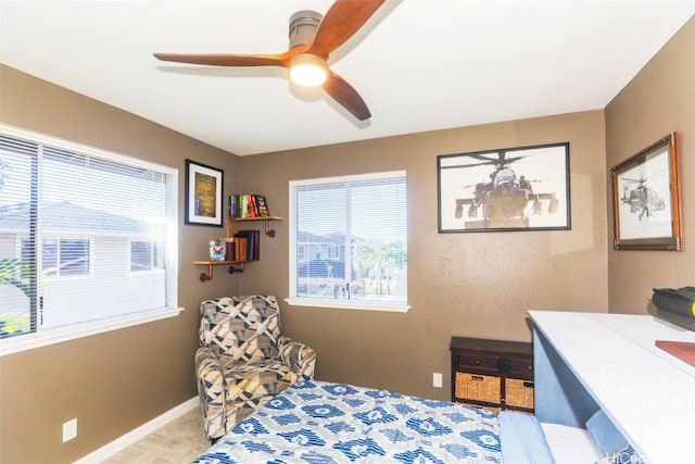 bedroom featuring ceiling fan and light carpet