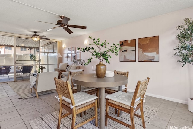 dining room with ceiling fan, light tile patterned flooring, and a textured ceiling