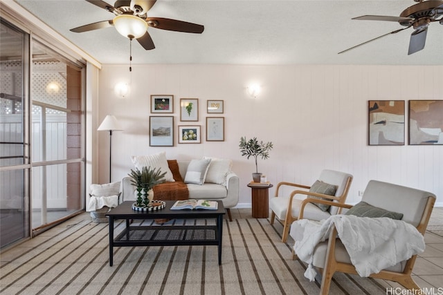 tiled living room featuring ceiling fan and a textured ceiling