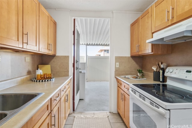 kitchen featuring white electric range oven, a textured ceiling, sink, light tile patterned floors, and light brown cabinets