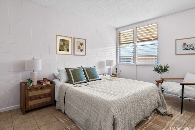 tiled bedroom featuring a textured ceiling