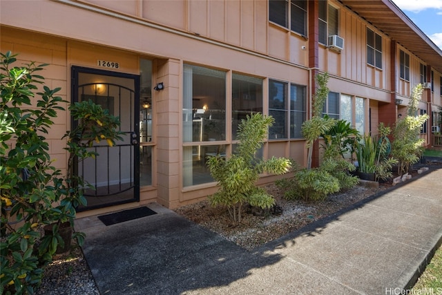 entrance to property featuring cooling unit