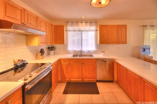 kitchen with decorative backsplash, light tile patterned flooring, sink, and appliances with stainless steel finishes