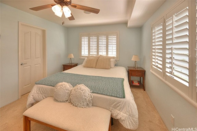 bedroom with light carpet and ceiling fan