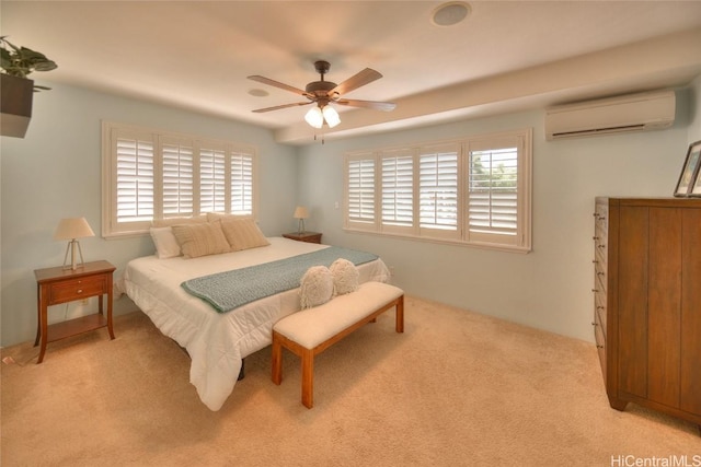 carpeted bedroom with a wall unit AC and ceiling fan