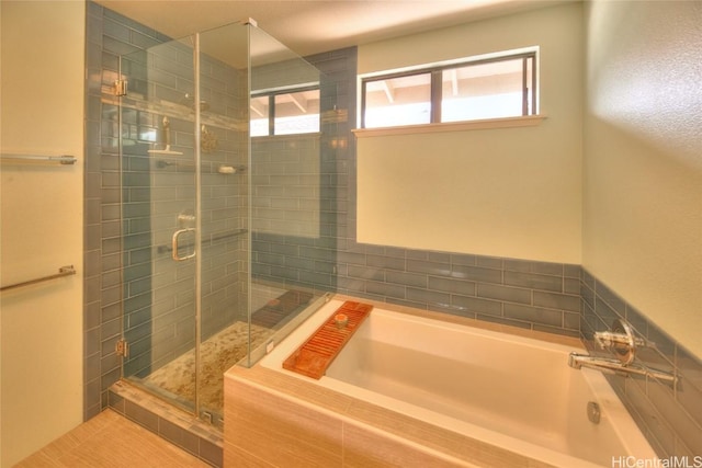 bathroom with independent shower and bath and a wealth of natural light