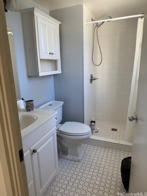 bathroom with toilet, vanity, and walk in shower