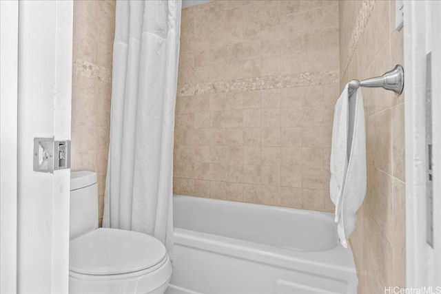 bathroom featuring toilet and shower / tub combo with curtain