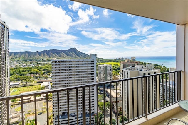 balcony featuring a water and mountain view