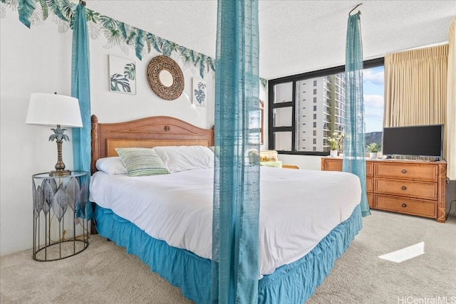 carpeted bedroom featuring expansive windows and a textured ceiling