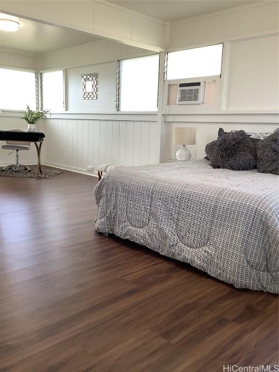 bedroom with dark hardwood / wood-style flooring and cooling unit