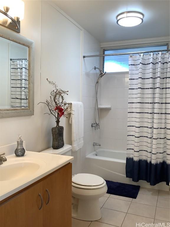 full bathroom with tile patterned flooring, shower / bath combination with curtain, vanity, and toilet