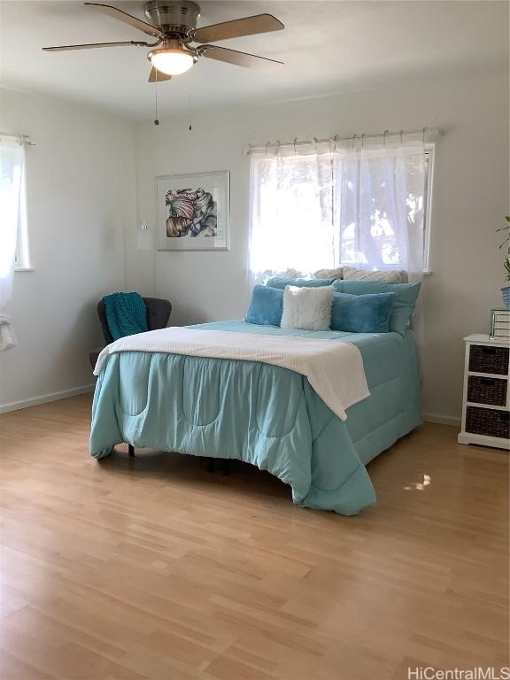 bedroom with ceiling fan and hardwood / wood-style flooring