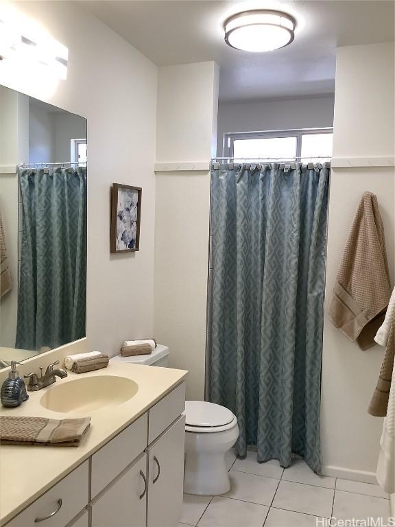 bathroom featuring tile patterned floors, vanity, and toilet