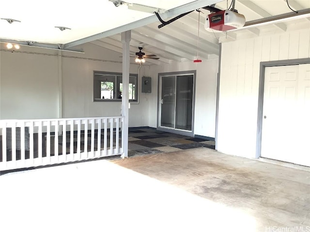 garage with electric panel, ceiling fan, and a garage door opener