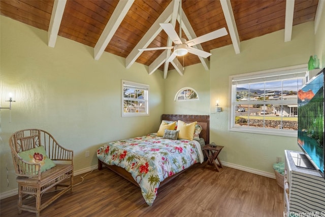 bedroom featuring multiple windows, lofted ceiling with beams, hardwood / wood-style flooring, and ceiling fan