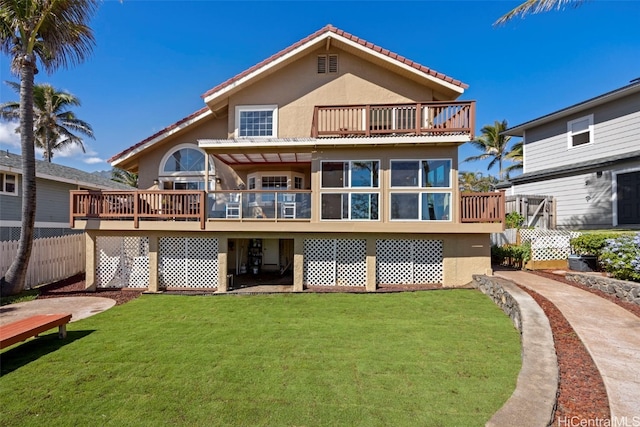 back of house with a wooden deck and a lawn