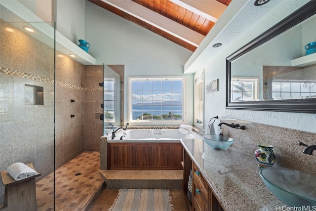 bathroom with plenty of natural light, lofted ceiling with beams, and tile patterned flooring