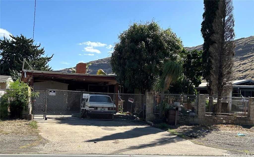 view of front of property featuring a carport and a mountain view