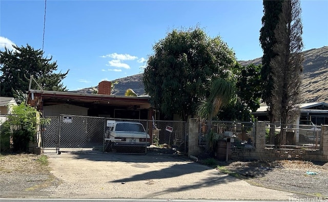 view of front of property featuring a carport and a mountain view