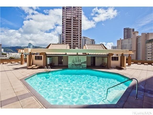 view of swimming pool with a patio area