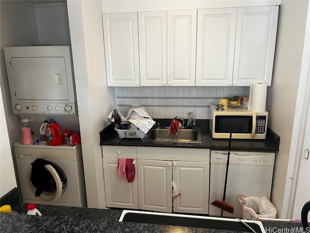 clothes washing area featuring stacked washer / drying machine and sink