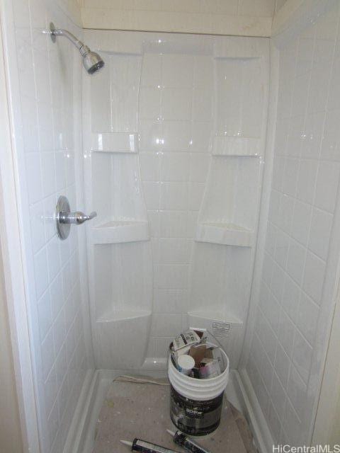 bathroom with tiled shower